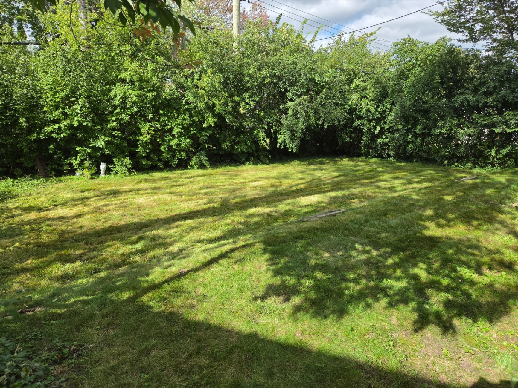 Freshly mowed and striped residential front lawn at a West Island Montreal home at golden hour